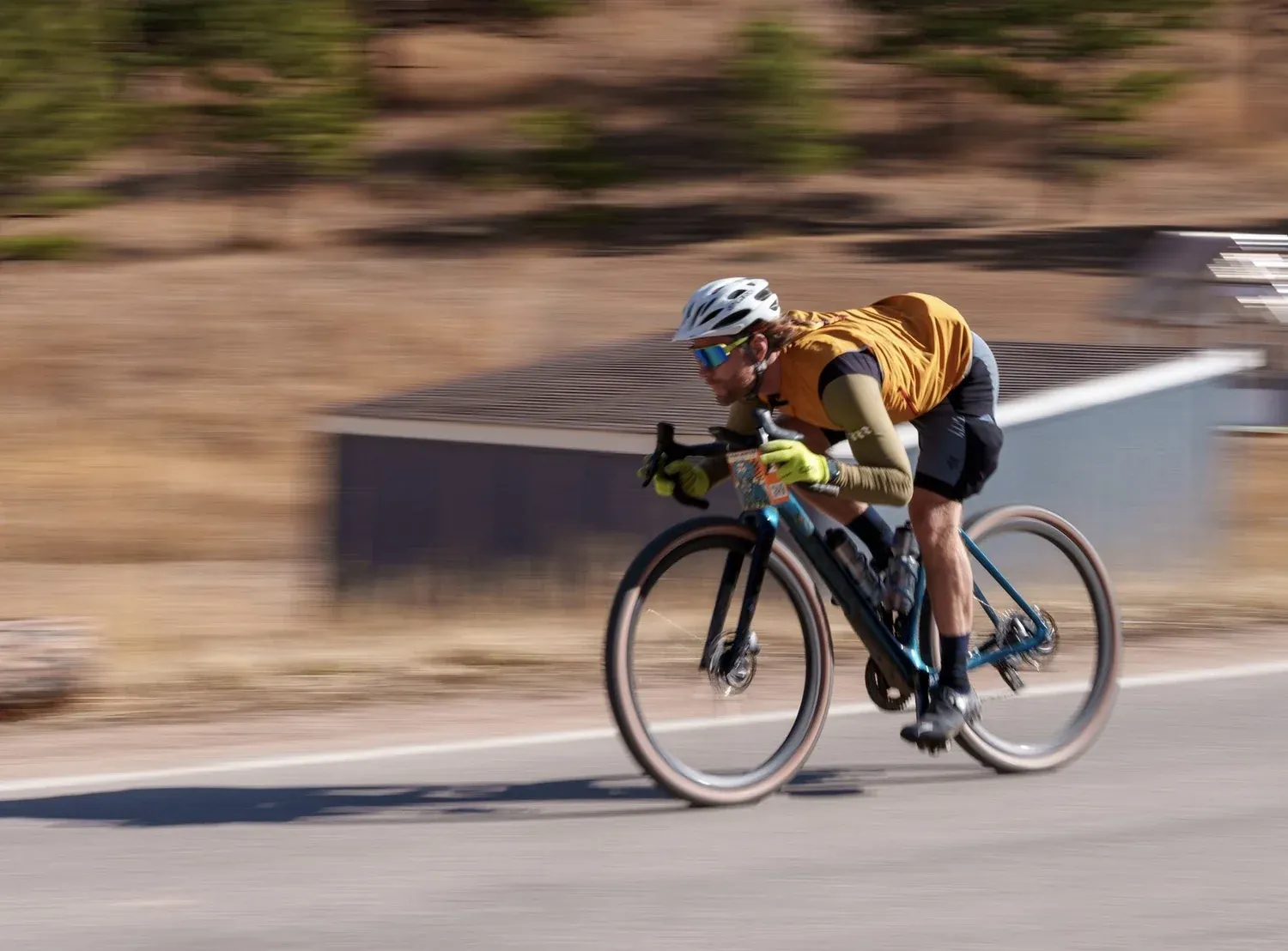 Cyclist sprinting on a paved road, motion blurred