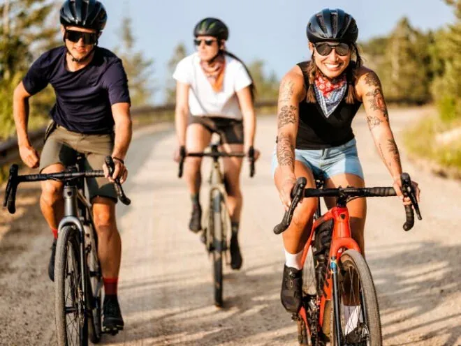 Group of gravel riders smiling on a dirt road