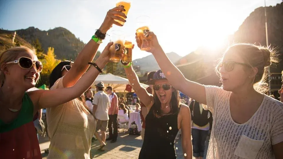 Friends cheersing drinks at the aid station