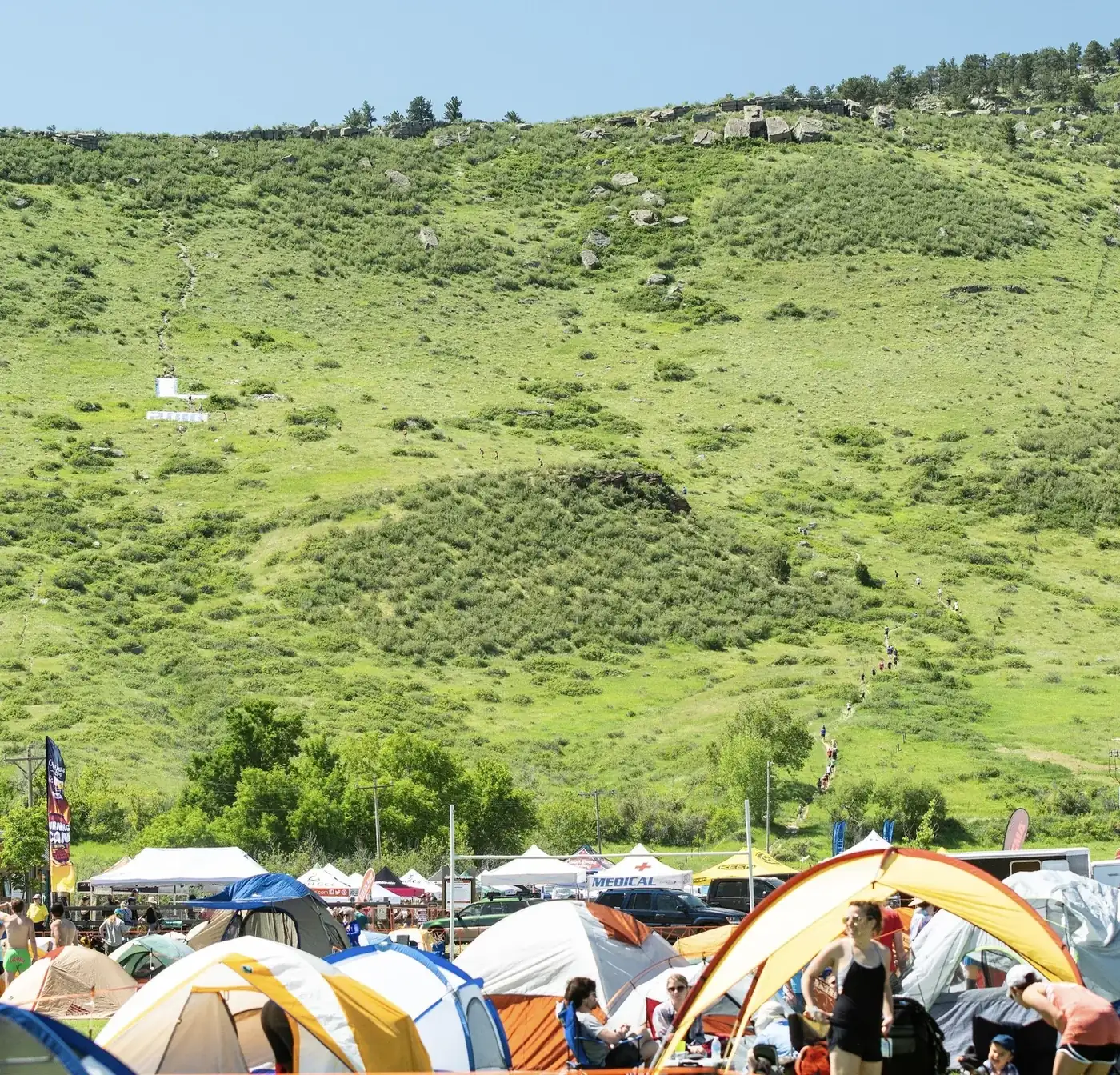 Tents on the hillside beside the course