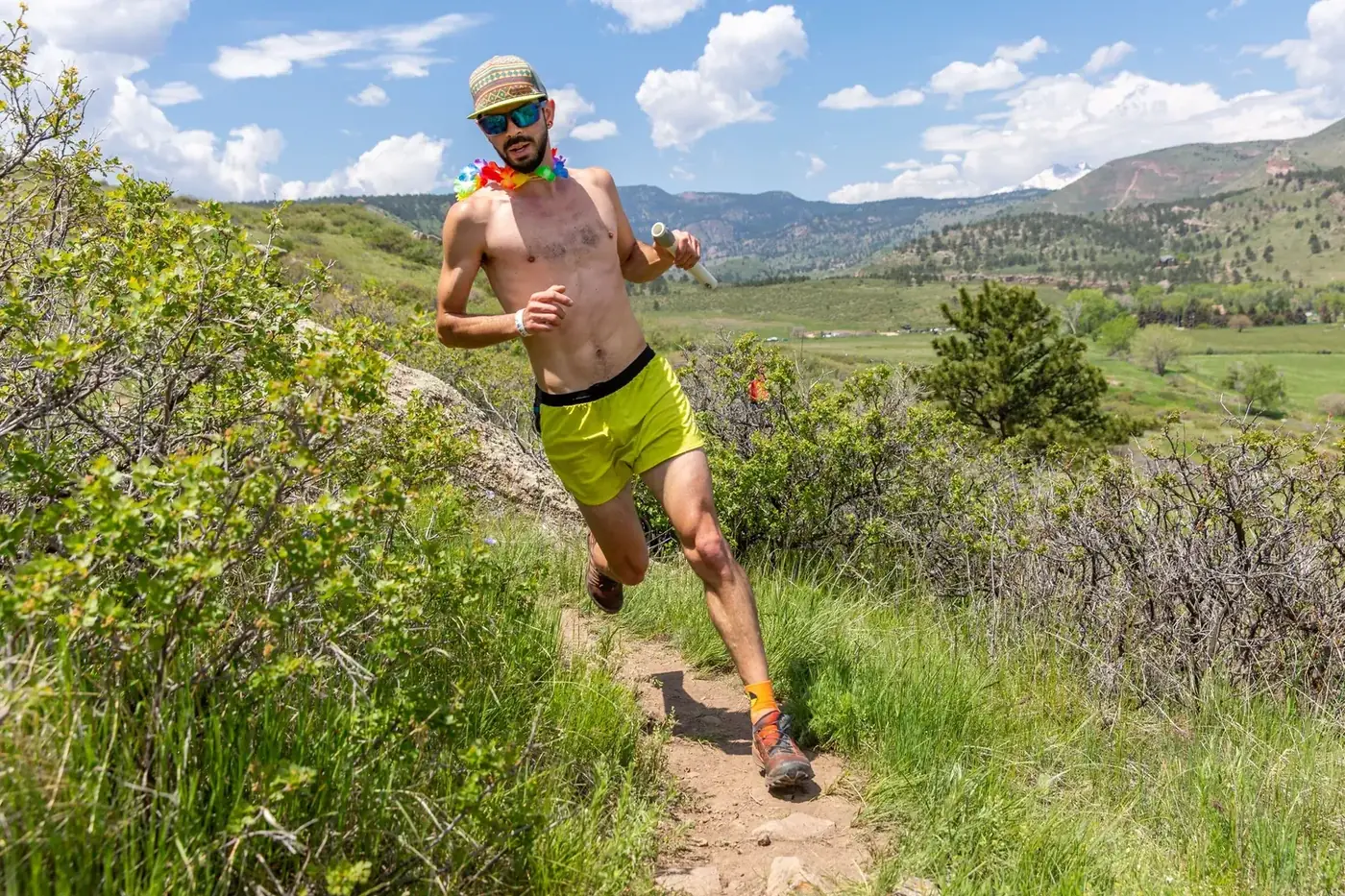 Runner descending the grassy trail