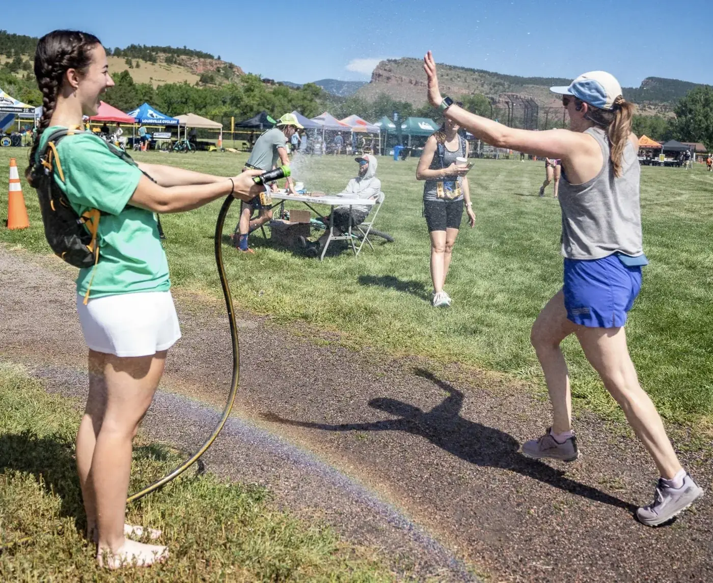 Volunteer handing water to a runner