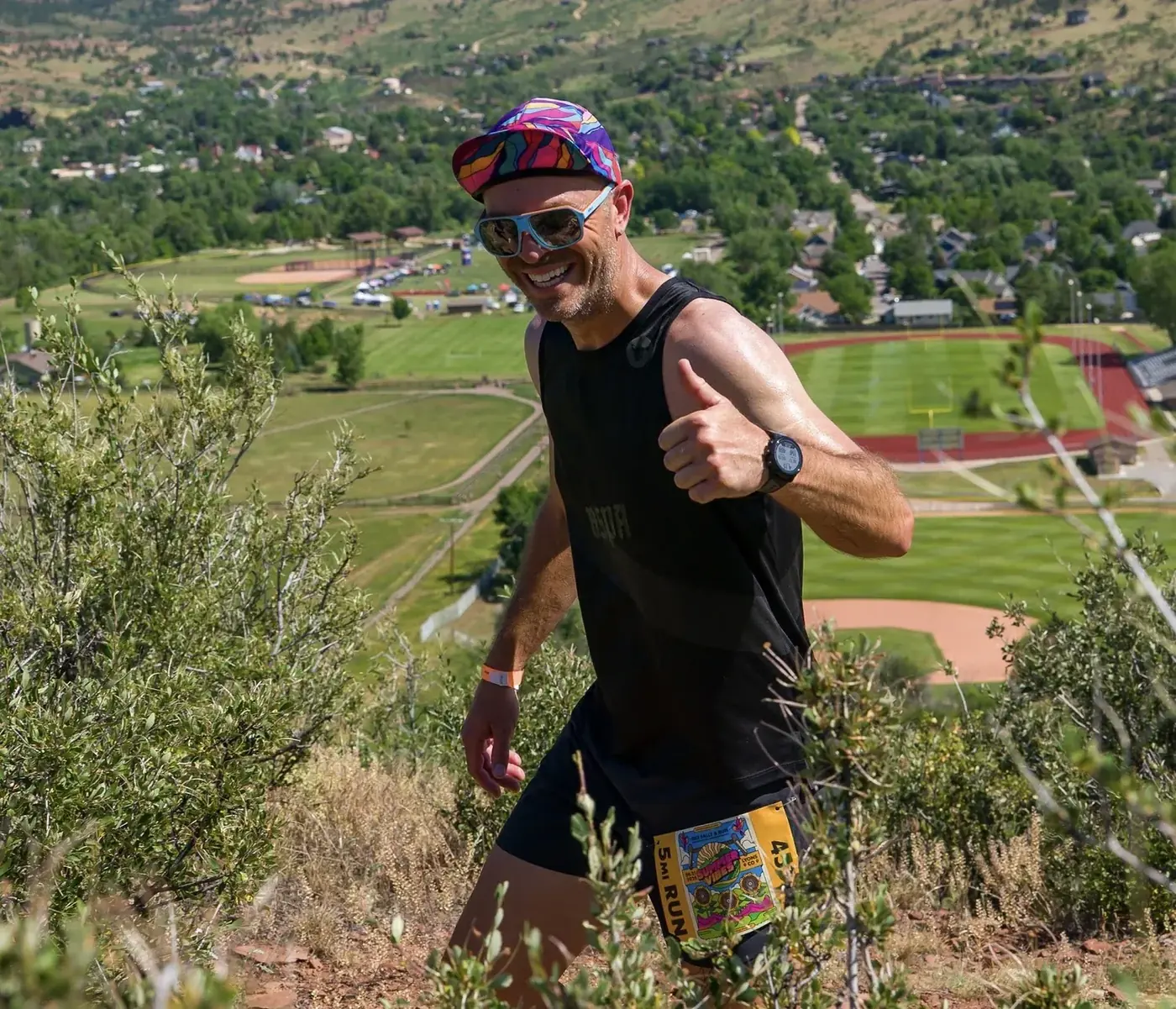 Runner on the hill above Lyons with the festival below